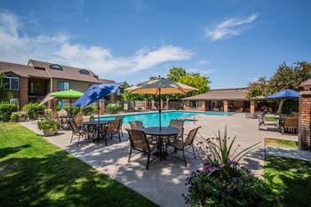 A poolside area with a table and chairs.